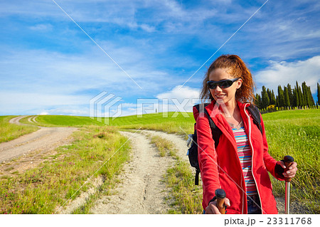 Tourist girl enjoying view of beautiful dry green wheat hills Tourist girl enjoying view of beautiful dry green wheat hills 23311768