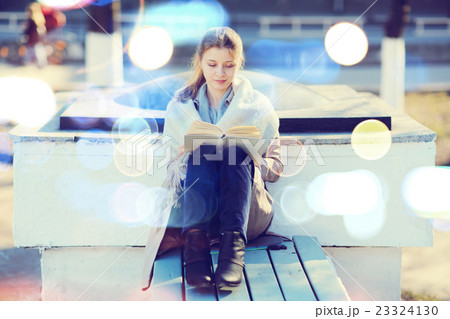 girl in autumn park with a book 23324130