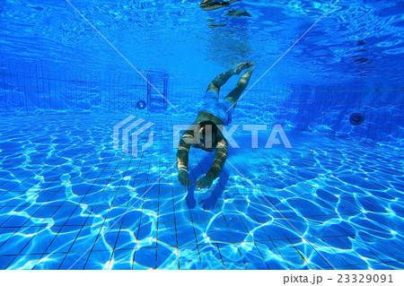 man dives into the pool underwater photo 23329091