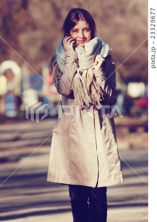spring photo beautiful girl in a coat in the city 23329677