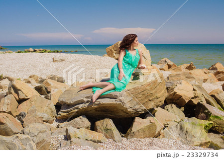 Young girl on summer beach with shell Young girl on summer beach with shell 23329734