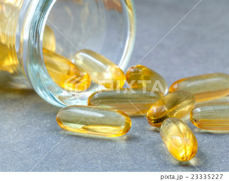 Close up capsules fish oil in Glass bottle . 23335227