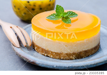 Passion fruit cheesecake with fresh mint leaves . Passion fruit cheesecake with fresh mint leaves . 23335395
