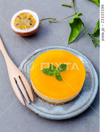 Passion fruit cheesecake with fresh mint leaves . Passion fruit cheesecake with fresh mint leaves . 23335396