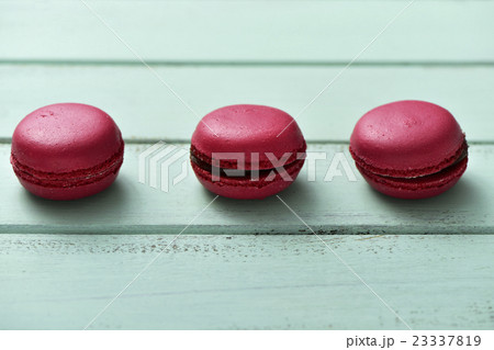 red macarons on a blue rustic surface 23337819