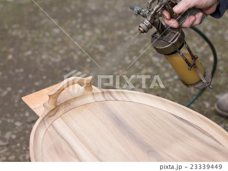 Carpenter is covering stool by lacquer Carpenter is covering stool by lacquer 23339449