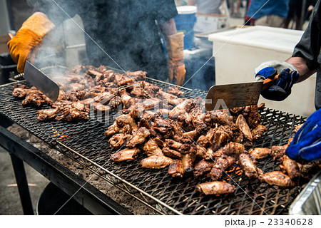 chicken wings and legs on barbecue grill  23340628