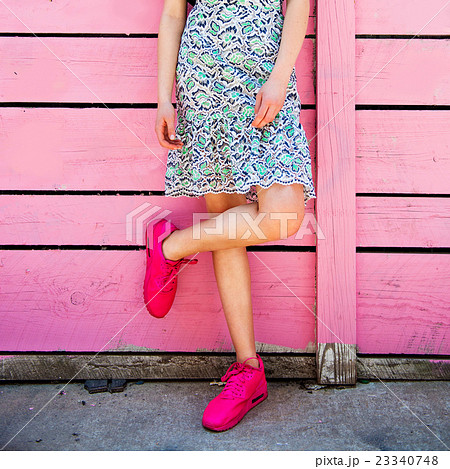 Pink sneakers on girl legs on grunge background Pink sneakers on girl legs on grunge background 23340748