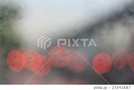 Blurred rainy window with red bokeh light 23341687