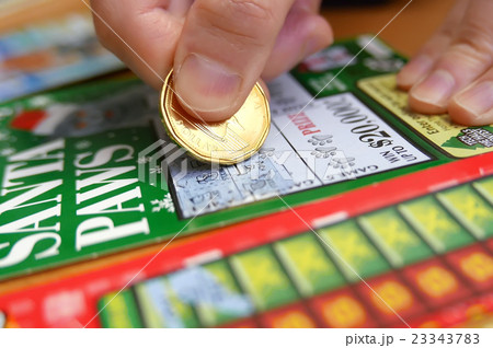 Woman scratching lottery tickets. 23343783
