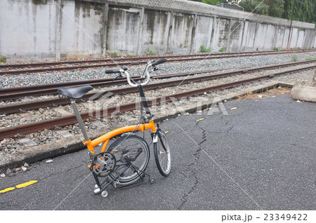 Folding bicycle parked at railroad station after r Folding bicycle parked at railroad station after r 23349422
