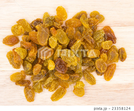 Yellow raisins on wood background. Yellow raisins on wood background. 23358124