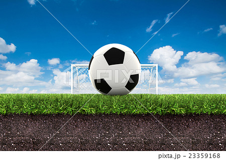 football on green grass with soil on blue sky.,3d  23359168