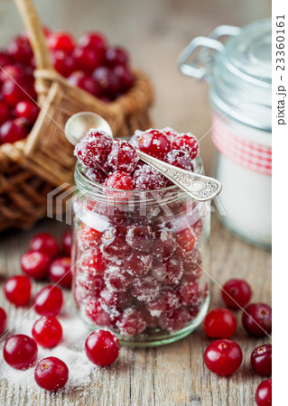 Cranberries with sugar in glass jar 23360161
