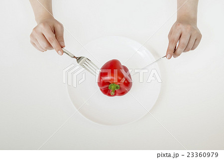 赤パプリカ1個をフォークとナイフで食べるダイエットイメージ 赤パプリカ1個をフォークとナイフで食べるダイエットイメージ 23360979