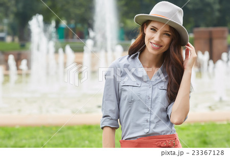 Woman in green city park enjoying the sunny day Woman in green city park enjoying the sunny day 23367128