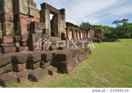 Ancient sandstone wall with green grass in the sun 23369110