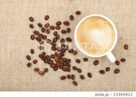 Latte cappuccino cup and coffee beans on canvas 23369923