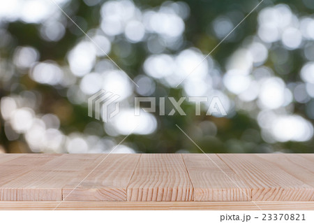 Wood table top on bokeh green background 23370821