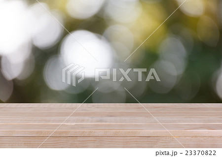 Wood table top on bokeh green background Wood table top on bokeh green background 23370822