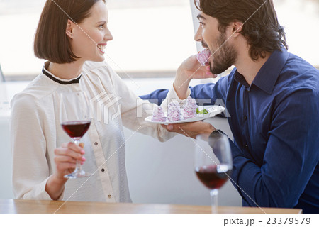 Pretty loving couple enjoying sweet food 23379579
