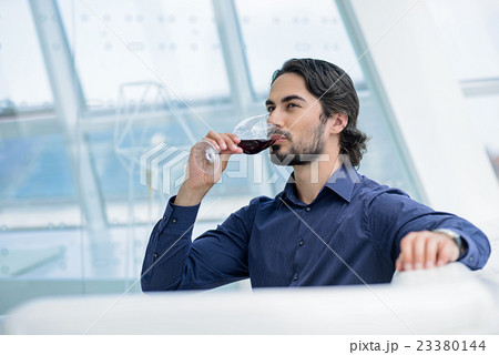 Confident man enjoying elegant drink Confident man enjoying elegant drink 23380144