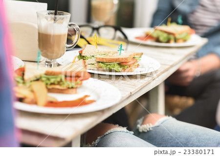 Happy friends having lunch in cafe 23380171