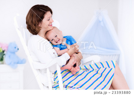 Mother and baby in white bedroom Mother and baby in white bedroom 23393880