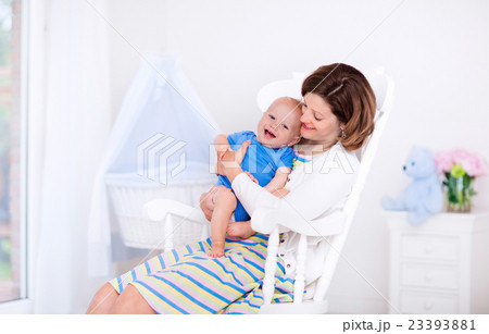 Mother and baby in white bedroom 23393881