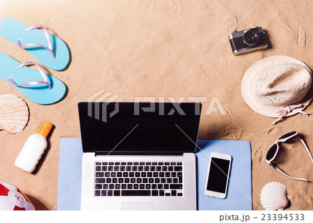 Summer vacation composition. Sandals, hat, laptop Summer vacation composition. Sandals, hat, laptop 23394533