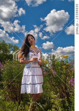 Attractive girl in sundress on meadow 23398930