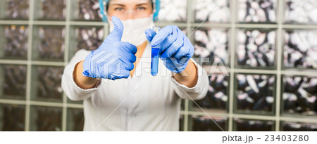 female lab technician giving thumbs up of success female lab technician giving thumbs up of success 23403280