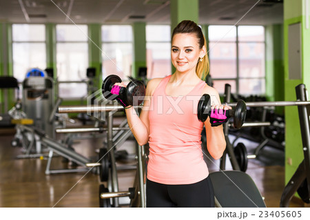 beautiful sporty woman with dumbbells 23405605
