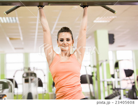 Sports young beautiful woman pulled out in the gym 23405608
