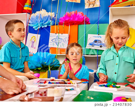 Group kids mold from plasticine in kindergarten . Group kids mold from plasticine in kindergarten . 23407830