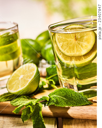 On wooden boards is glass with green mohito drink. On wooden boards is glass with green mohito drink. 23407847
