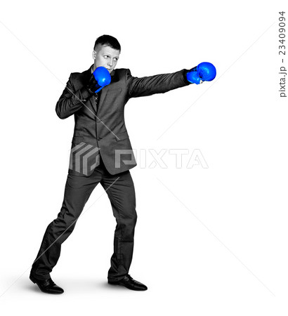 Serious businessman in sports boxing stance Serious businessman in sports boxing stance 23409094