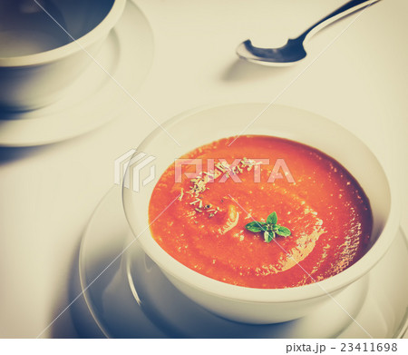 Picture of a bowl with tomato cream soup. 23411698