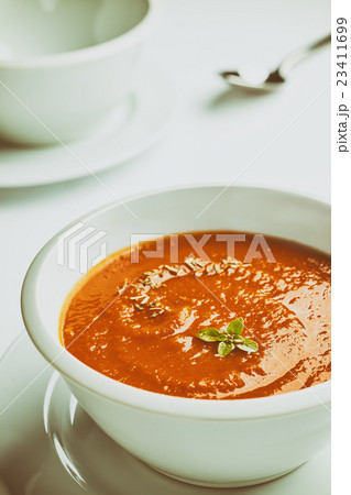 Retro stylized white bowl with tomato soup. 23411699