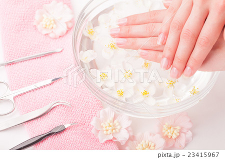 Beautiful woman's hands with manicure in bowl of Beautiful woman's hands with manicure in bowl of 23415967