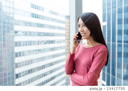 Woman talking on smart phone Woman talking on smart phone 23417750