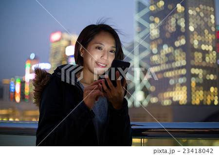 Woman using her mobile phone in Hong Kong 23418042