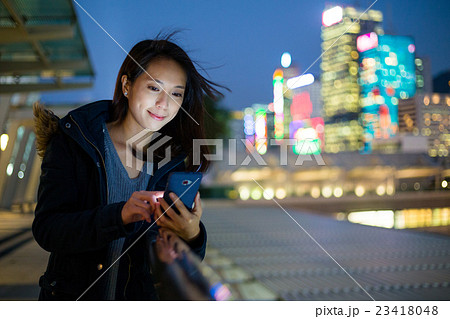 Woman use of mobile phone at Hong Kong 23418048