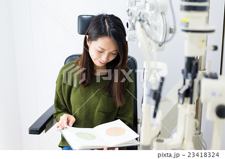 Woman doing the colour test on book Woman doing the colour test on book 23418324