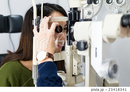 Woman having her eyes examined by eye doctor 23418341