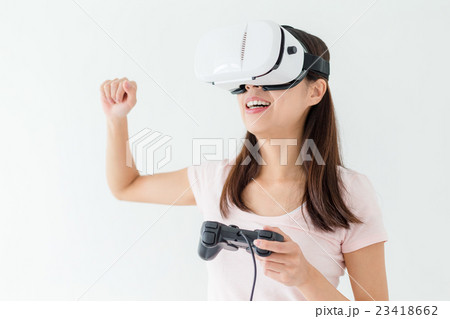 Young Woman play video game with virtual reality device 23418662