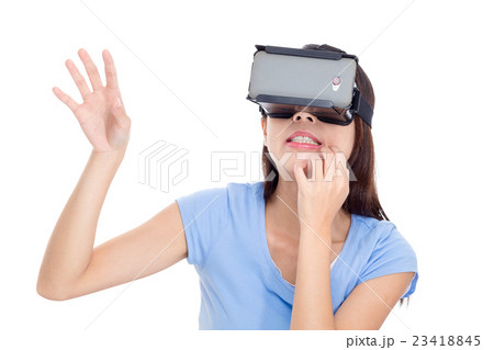 Young woman looking though virtual reality device Young woman looking though virtual reality device 23418845