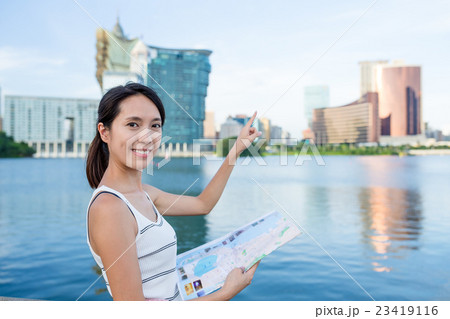 Young Woman use of city map in Macau Young Woman use of city map in Macau 23419116