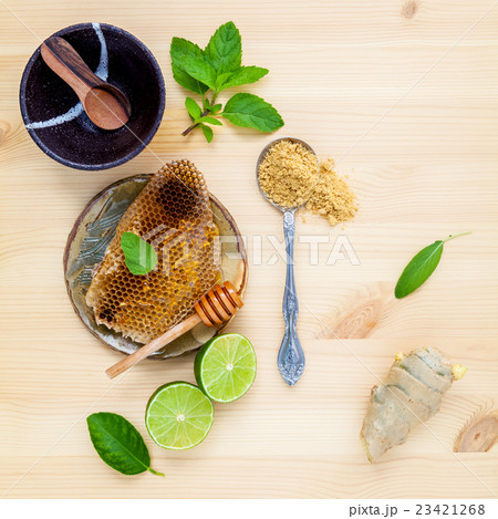Honeycomb in  bowl with herbs . 23421268