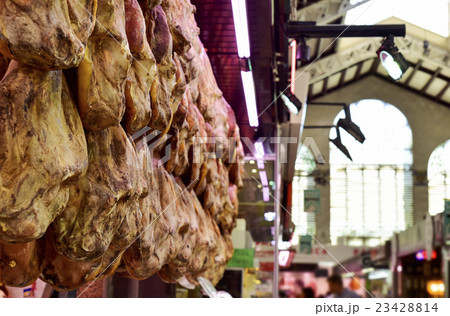 serrano ham on sale in a public market in Spain 23428814